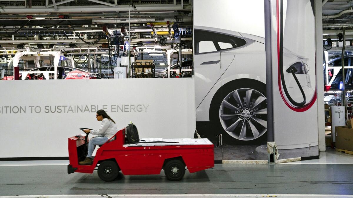 Inside Tesla's Fremont, Calif., automobile plant, which has been ramping up production of the new Model 3 sedan.