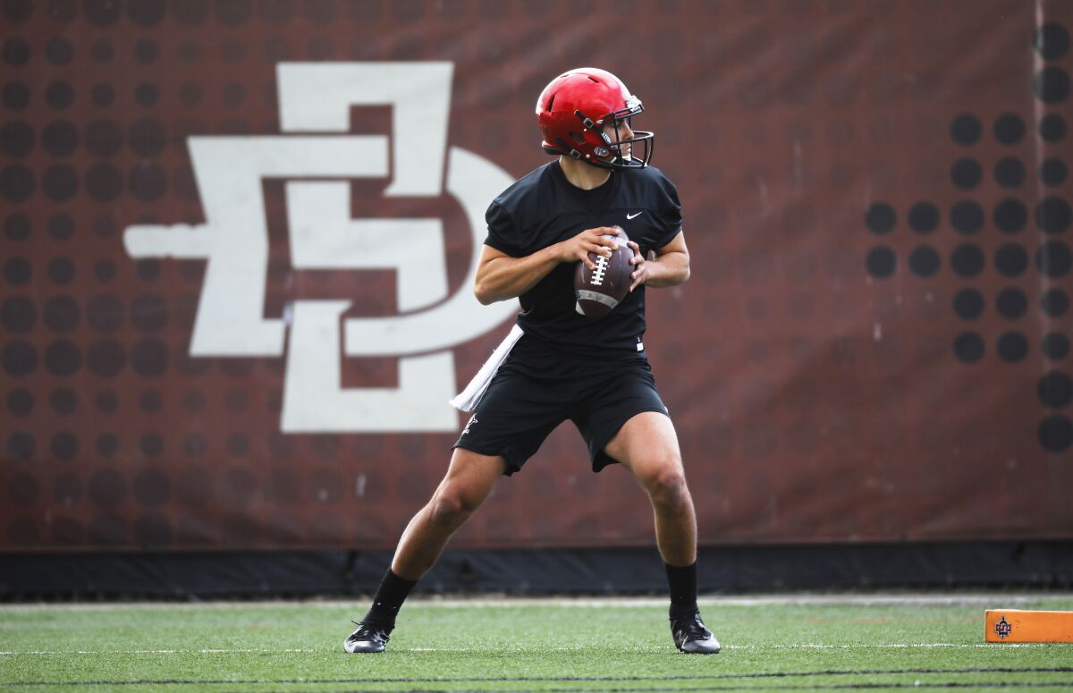 San Diego State quarterback Carson Baker drops back during a spring workout on the SDSU practice field.