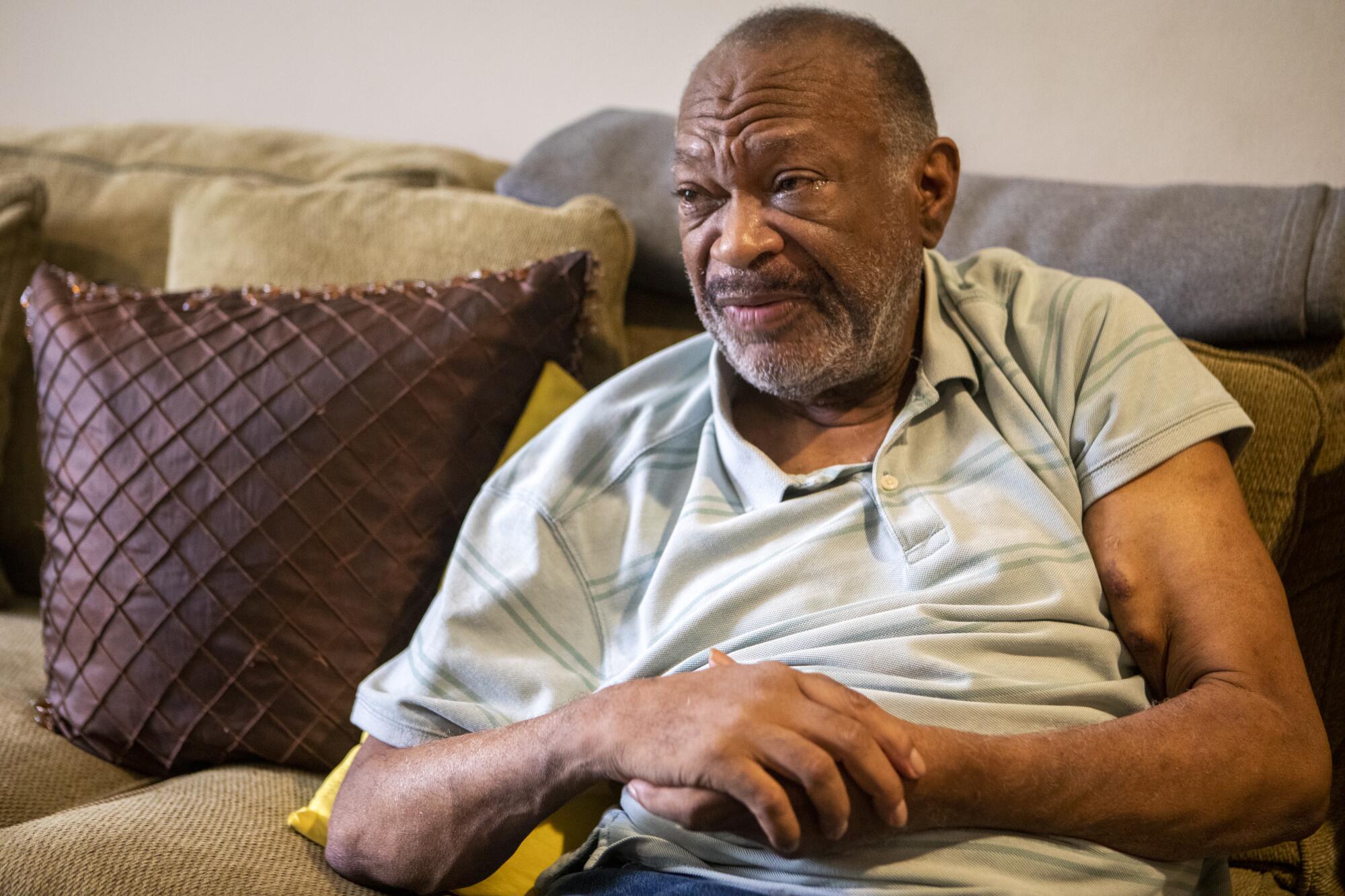Kidney patient Roland Coleman on a couch.