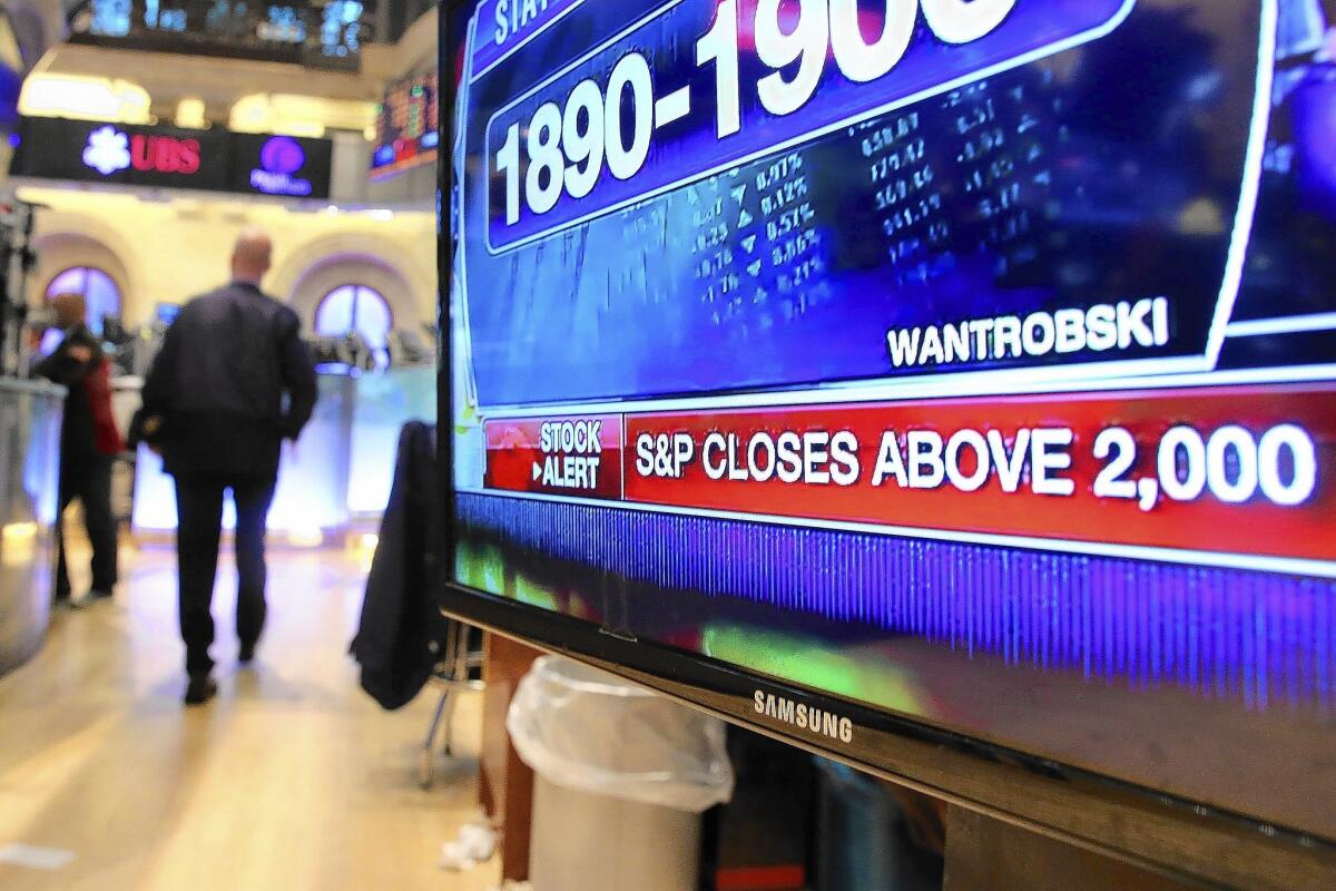 The S&P 500’s latest record takes the index to more than triple its low point of 666 on March 9, 2009, when the bull market began. Above, a TV monitor displays news on the floor of the New York Stock Exchange on Tuesday.