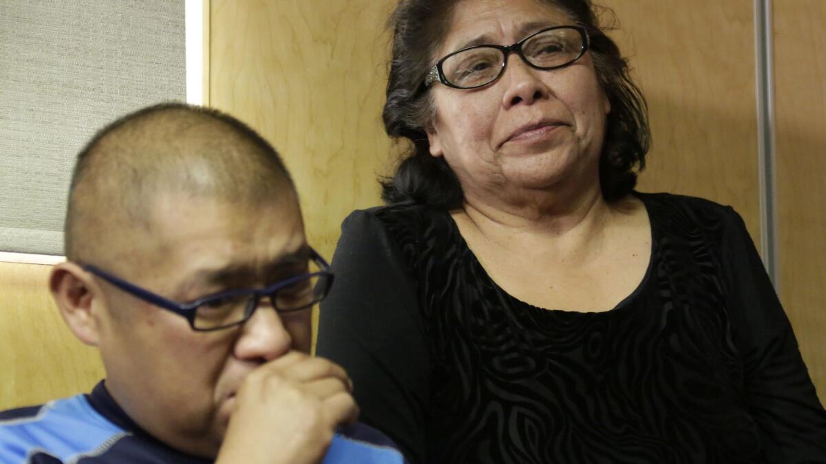 Abelardo Guzman, left, and Gloria Gonzalez weep at a 2016 news conference as their attorney describes the shooting of Norma Guzman.