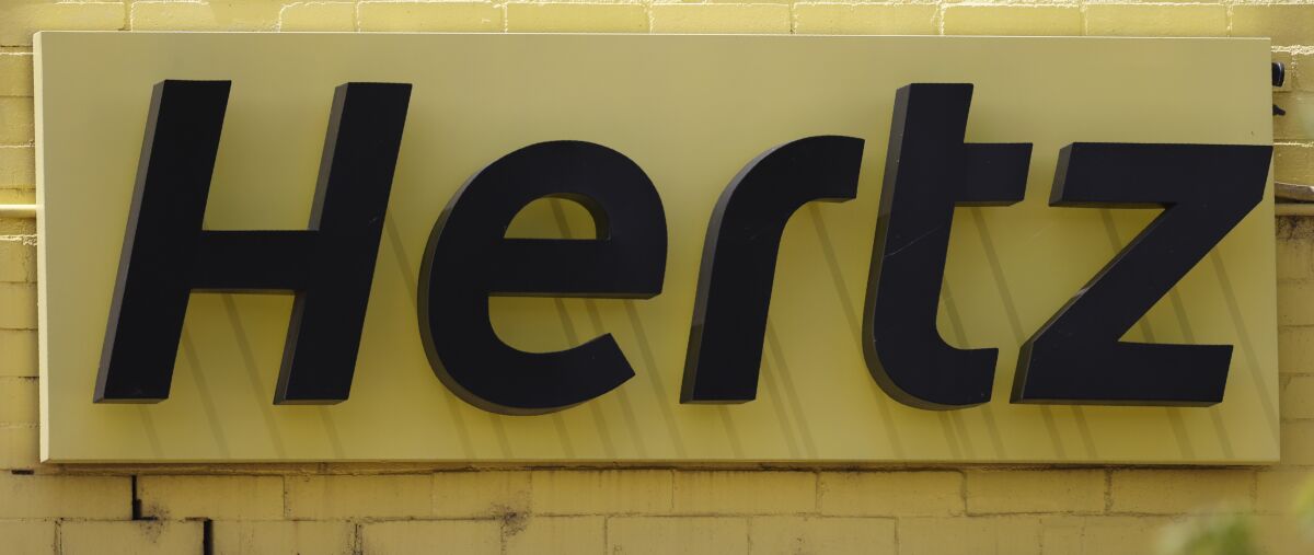 FILE - The company logo is shown on the exterior of a closed Hertz car rental office Saturday, May 23, 2020, in south Denver. The car rental company has named industry veteran Mark Fields as its interim CEO. Fields, the former president and CEO of Ford Motor Co., joined Hertz’s board in June. He takes over the top post at Hertz from Paul Stone, who will now serve as the company’s president and chief operations officer. Hertz filed for bankruptcy protection in May 2020, hurt by the plunge in travel during the pandemic. (AP Photo/David Zalubowski)