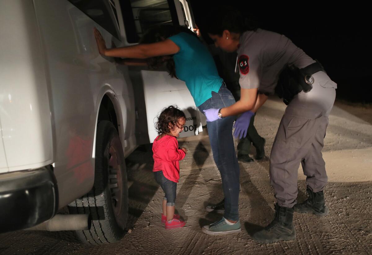 One of the images repeatedly seen in media coverage of family separations: A two-year-old Honduran girl cries as her asylum-seeking mother is searched and detained near the U.S.-Mexico border on June 12, 2018 in McAllen, Texas.