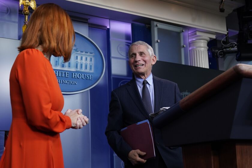 White House press secretary Jen Psaki speaks with Dr. Anthony Fauci, director of the National Institute of Allergy and Infectious Diseases, during a press briefing in the James Brady Press Briefing Room at the White House, Thursday, Jan. 21, 2021, in Washington. (AP Photo/Alex Brandon)