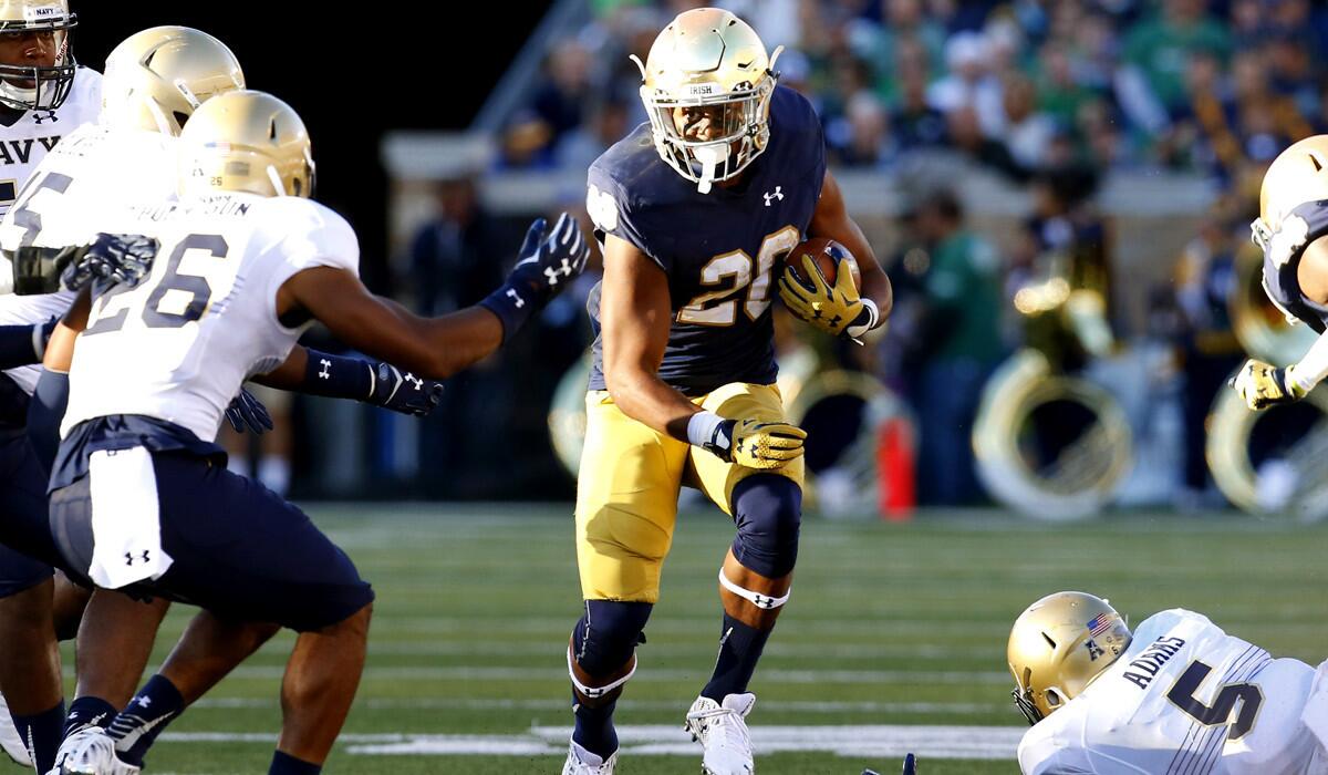 Notre Dame running back C.J. Prosise runs through Navy defenders during the second half on Saturday.