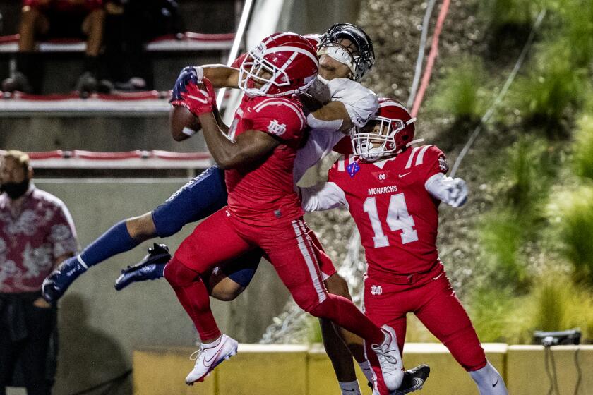 Mater Dei's Shu'yab Brinkley intercepts a pass in the end zone intended for St John Bosco's James Chedon on April 17, 2021.