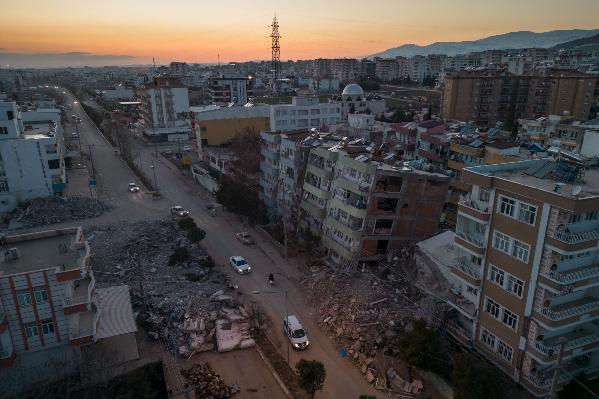 An aerial view of damaged buildings and rubble in the streets