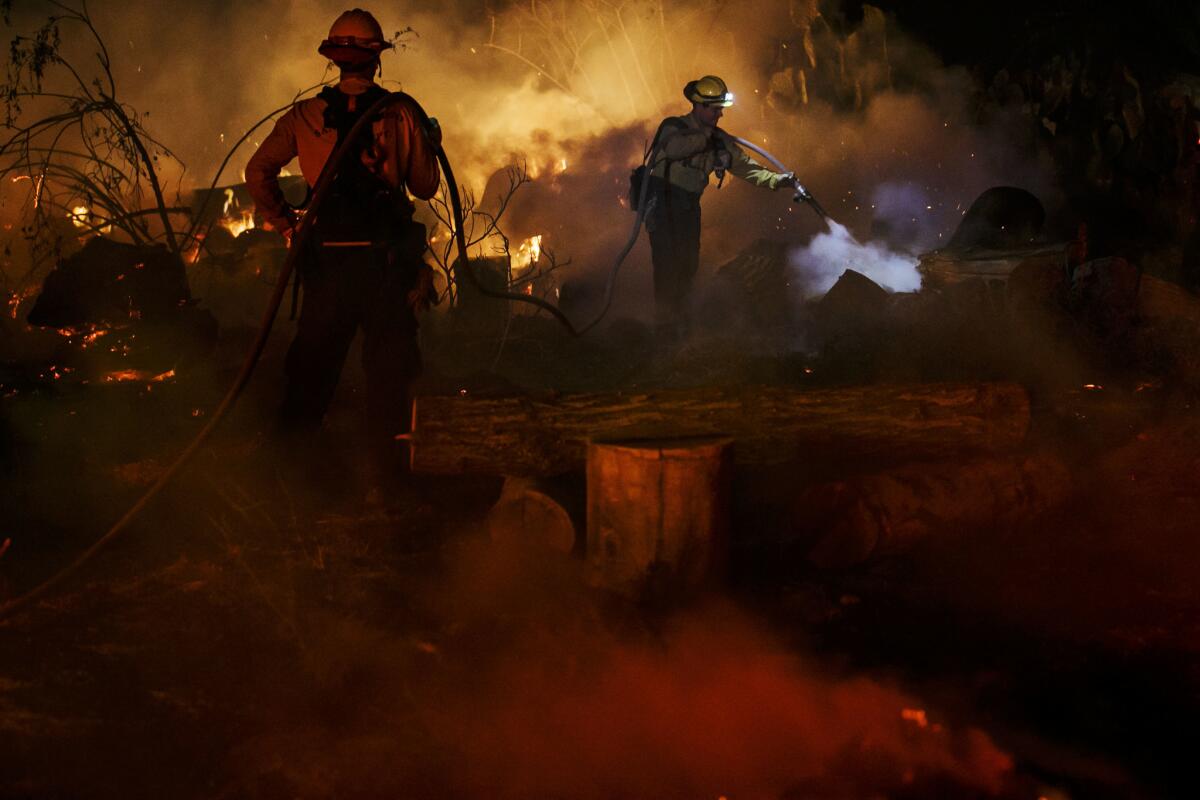 Fire crews work to put out flames on North Rice Road in Ojai.