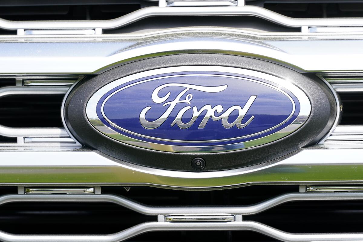 A logo on a vehicle at a Ford dealership in Springfield, Pa., Tuesday, April 26, 2022. Ford says it has contracts to deliver enough batteries to produce electric vehicles at a rate of 600,000 globally per year by late in 2023. The company says Thursday, July 21, that Contemporary Amperex Technology Co. of China will supply new lithium-iron phosphate batteries starting next year. (AP Photo/Matt Rourke, File)