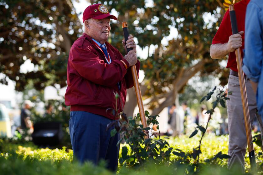 Navy veteran Tom Crosby holds a shovel as he waits to bury a time capsule during the centennial celebration of Liberty Station at Point Loma on Sunday, Oct. 29, 2023. Crosby, 90, was a civilian POW at Santo Tomas Internment Camp in the Philippines for three years during World War 2. After getting rescued, Crosby joined the Navy at the Naval Training Center in 1953 to give thanks to the U.S.