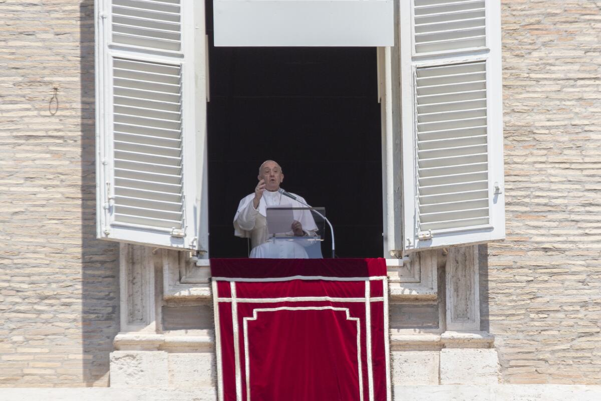 Pope Francis delivers his message from the window of his studio  overlooking St. Peter's Square at the Vatican on Sunday.