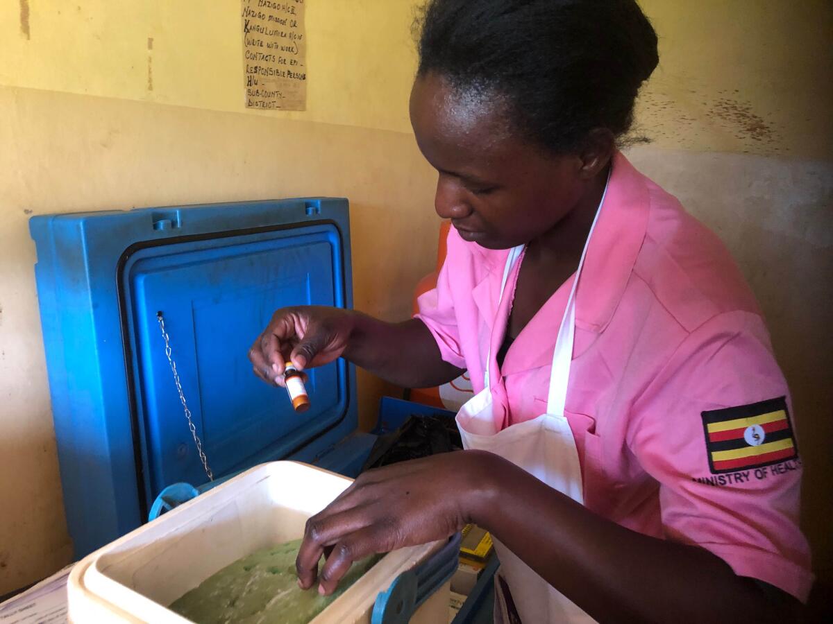 Health worker Sharita Ndagire packs vials of measles vaccine