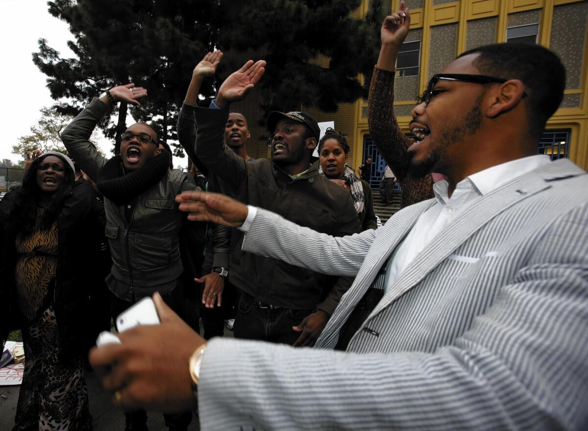 Cecil Thompson, right, and other former students present a musical tribute to their teacher Iris Stevenson in front of Crenshaw High School in Los Angeles. Stevenson, the school's longtime and well-known choir director, was removed from the classroom in December and has been assigned to L.A. Unified offices pending an investigation of unspecified allegations.
