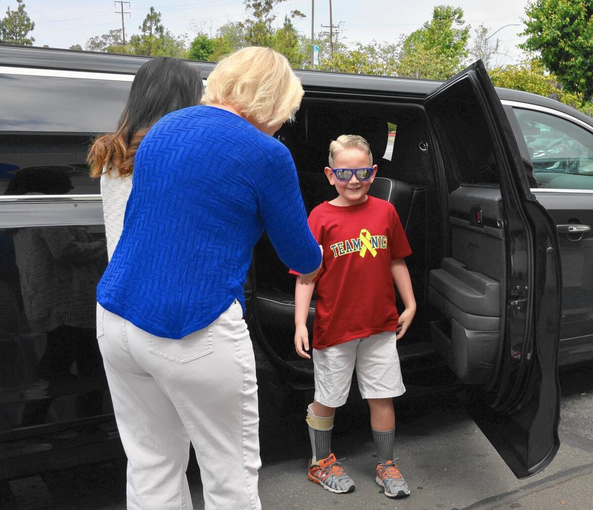 Nico, a Huntington Beach native who has bone cancer, arrives by limousine Friday at his eighth-birthday celebration at Toys R Us in Huntington Beach, where he learned his wish to visit Legoland would be granted by Make-A-Wish.