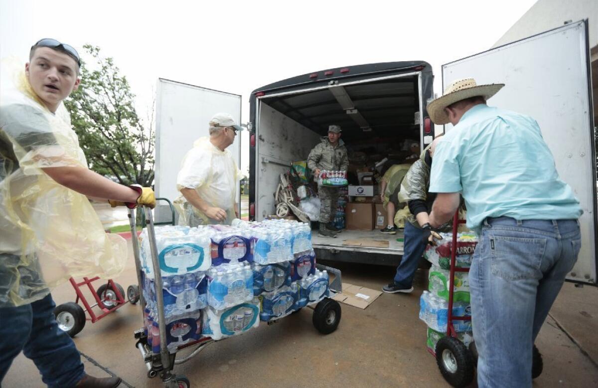 Volunteers unload relief supplies at the First Baptist Church of Moore, Okla.