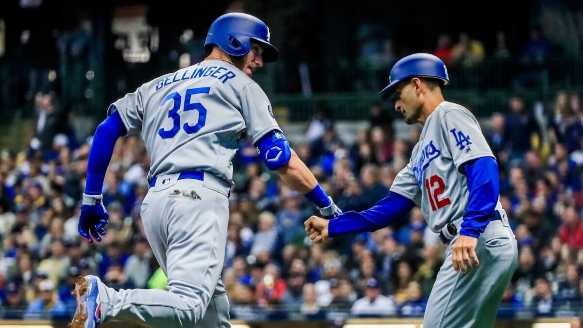 The Dodgers' Cody Bellinger celebrates with third base coach Dino Ebel after hitting a home run in the sixth inning.