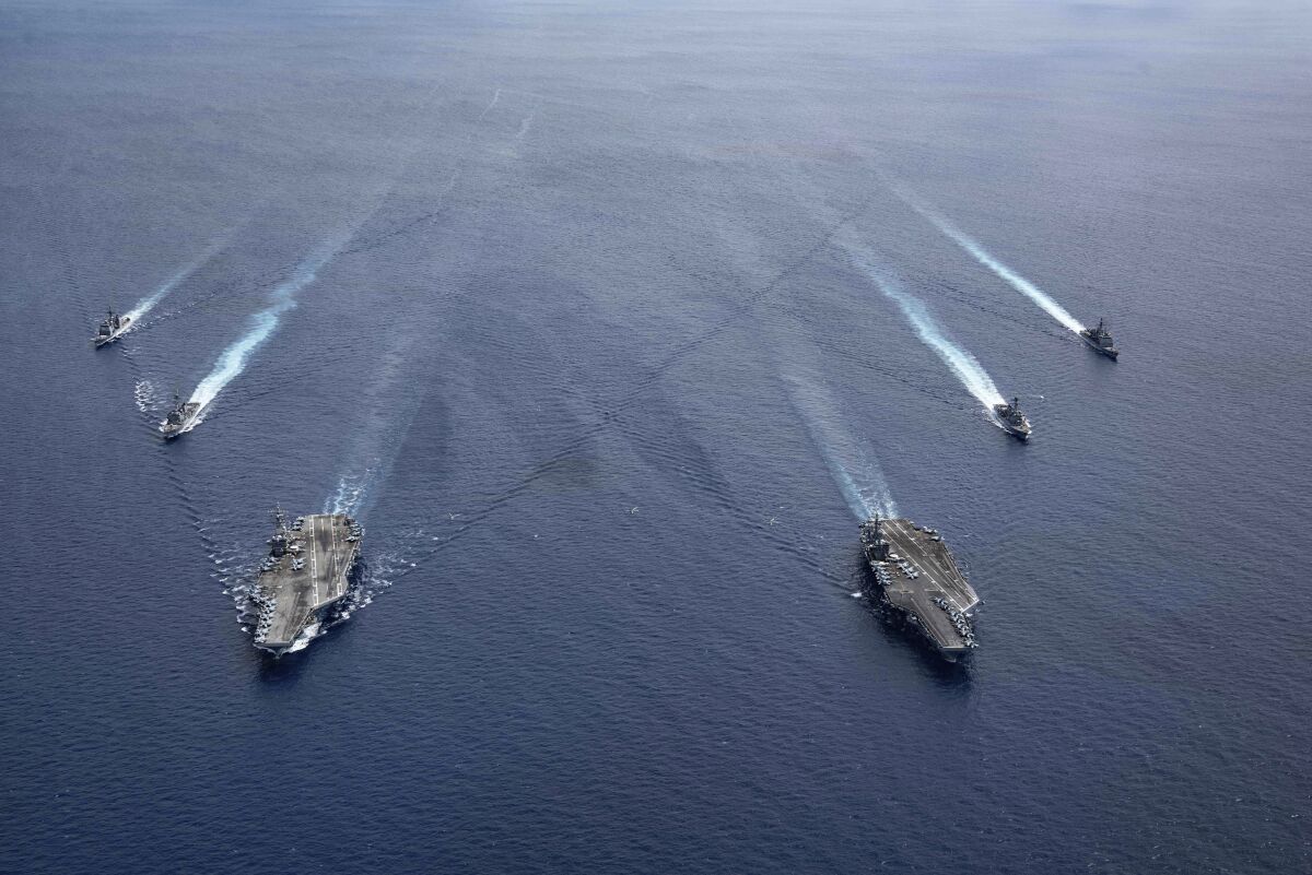 U.S. Navy cruisers steam in formation in the South China Sea.