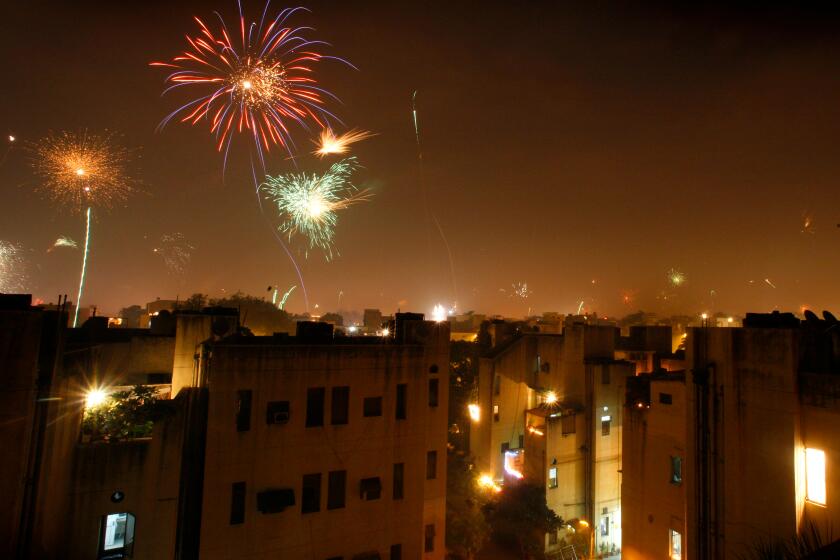 Fireworks light up the sky in celebration of Diwali, the festival of lights, in New Delhi, India, Saturday, Oct.17, 2009. Diwali was celebrated across India on Saturday with prayers and fireworks .The festival marks the homecoming of Hindu God Rama to Ayodhya after a 14-year exile in the forest following his victory over Ravana. (AP Photo/Manish Swarup)