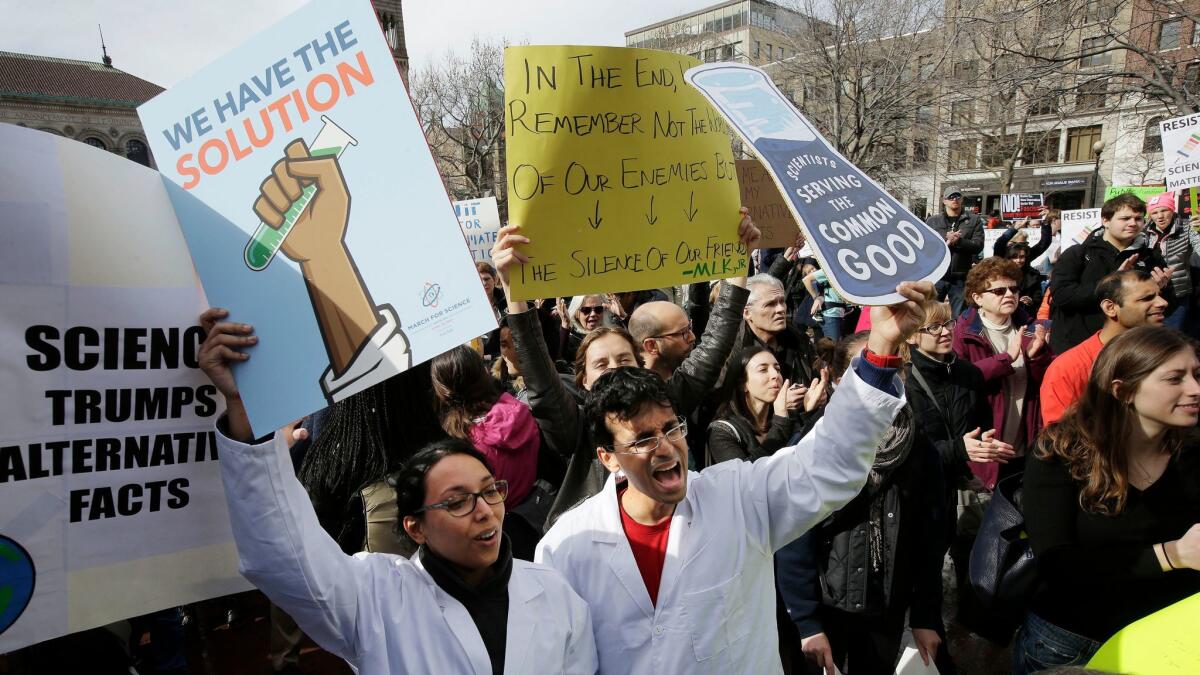 Members of the scientific community, environmental advocates, and supporters demonstrate against the Trump administration's stance on climate change on Feb. 19, in Boston.