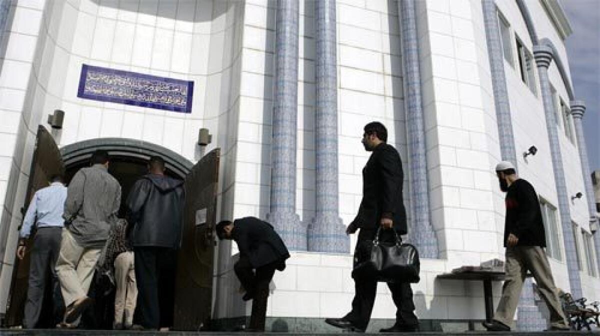 PRAYERS: Worshipers arrive at the King Fahd Mosque on Friday. Skeptics of the police program say U.S. Muslims are dispersed, reject extremism, are generally satisfied with their lives and have little in common with their counterparts in Europe, where low-income enclaves can breed terrorism.