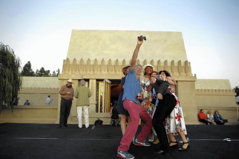 Tod Mesirow and other members of the Barnsdall Art Park Foundation gather to make a selfie during a 24-hour opening of Hollyhock House.