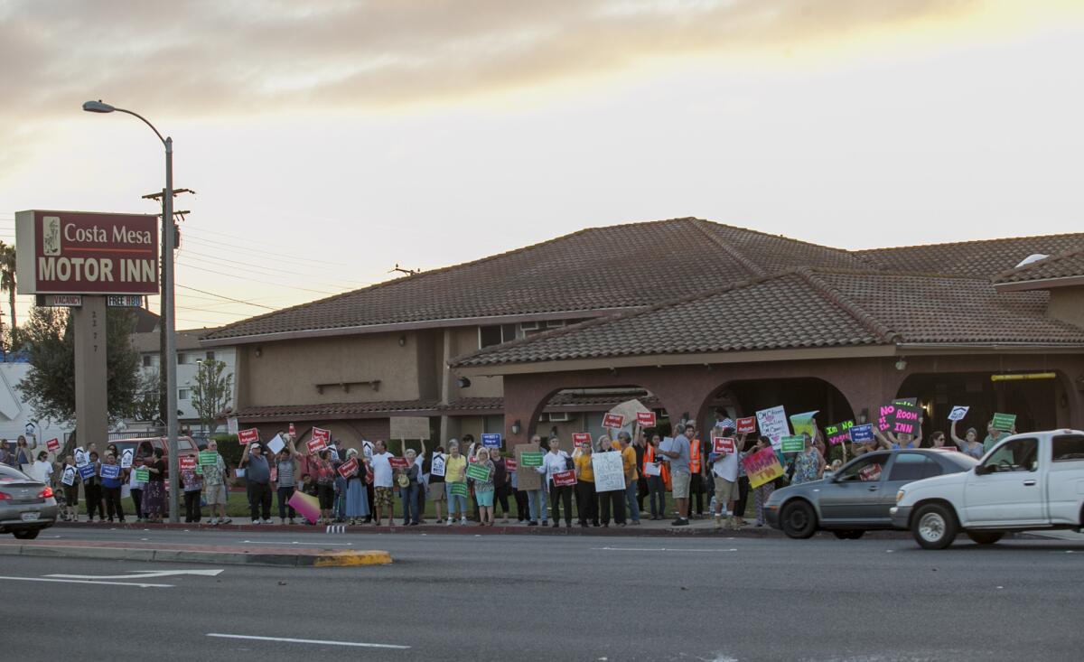 Affordable housing advocates protest in front of the Costa Mesa Motor Inn on Oct. 22.