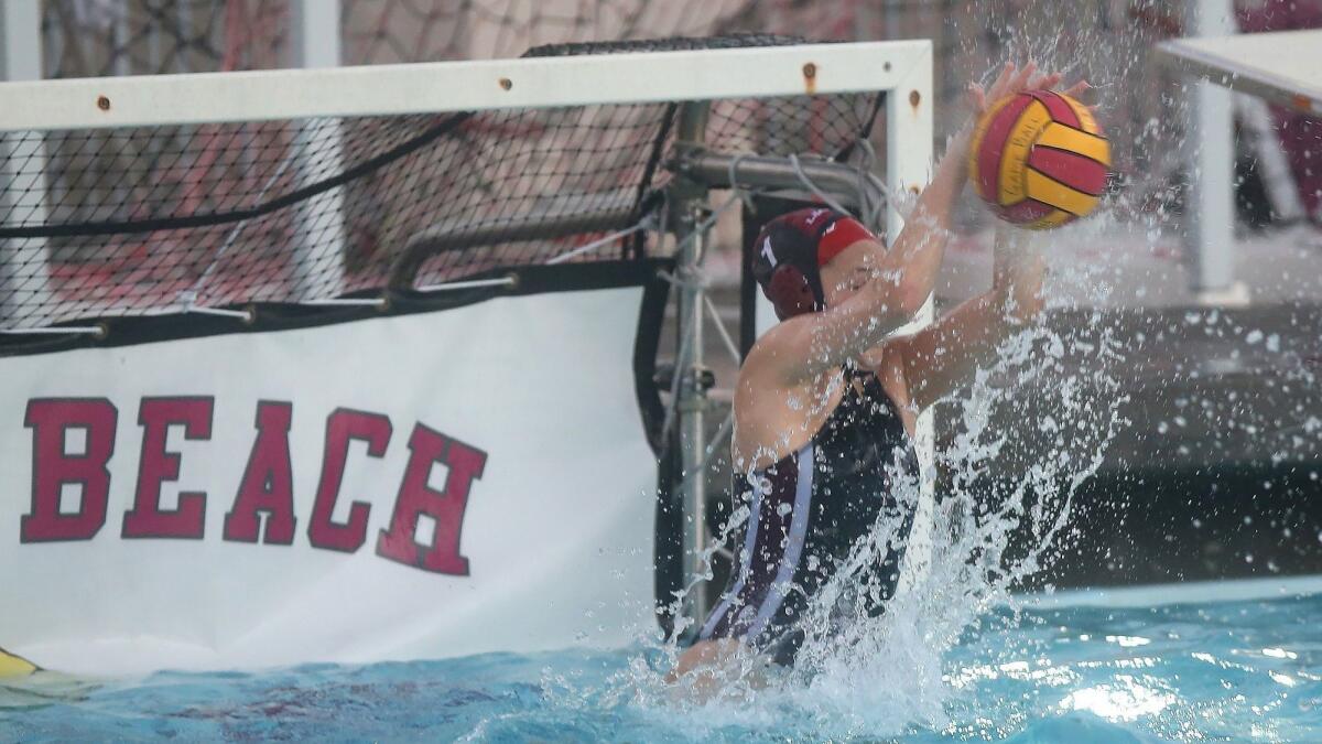 Laguna Beach High goalkeeper Quinn Winter stops a shot during a nonleague water polo game against visiting Mater Dei on Friday.