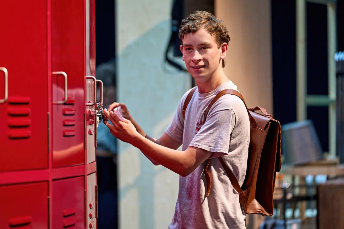 A teenage actor on a set opens his locker