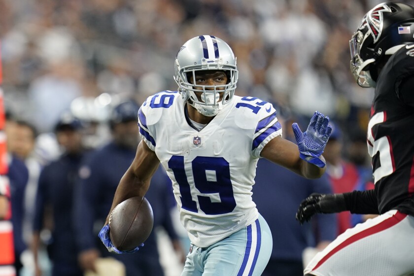 Dallas Cowboys wide receiver Amari Cooper carries the ball after a reception against the Falcons on Nov. 14.