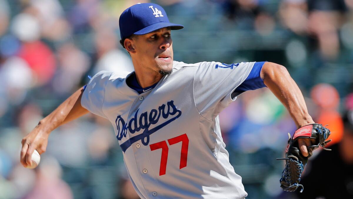 Dodgers starter Carlos Frias delivers a pitch in the first inning of a 16-2 loss to the Colorado Rockies on Wednesday. Frias gave up eight earned runs in less than an inning of work.