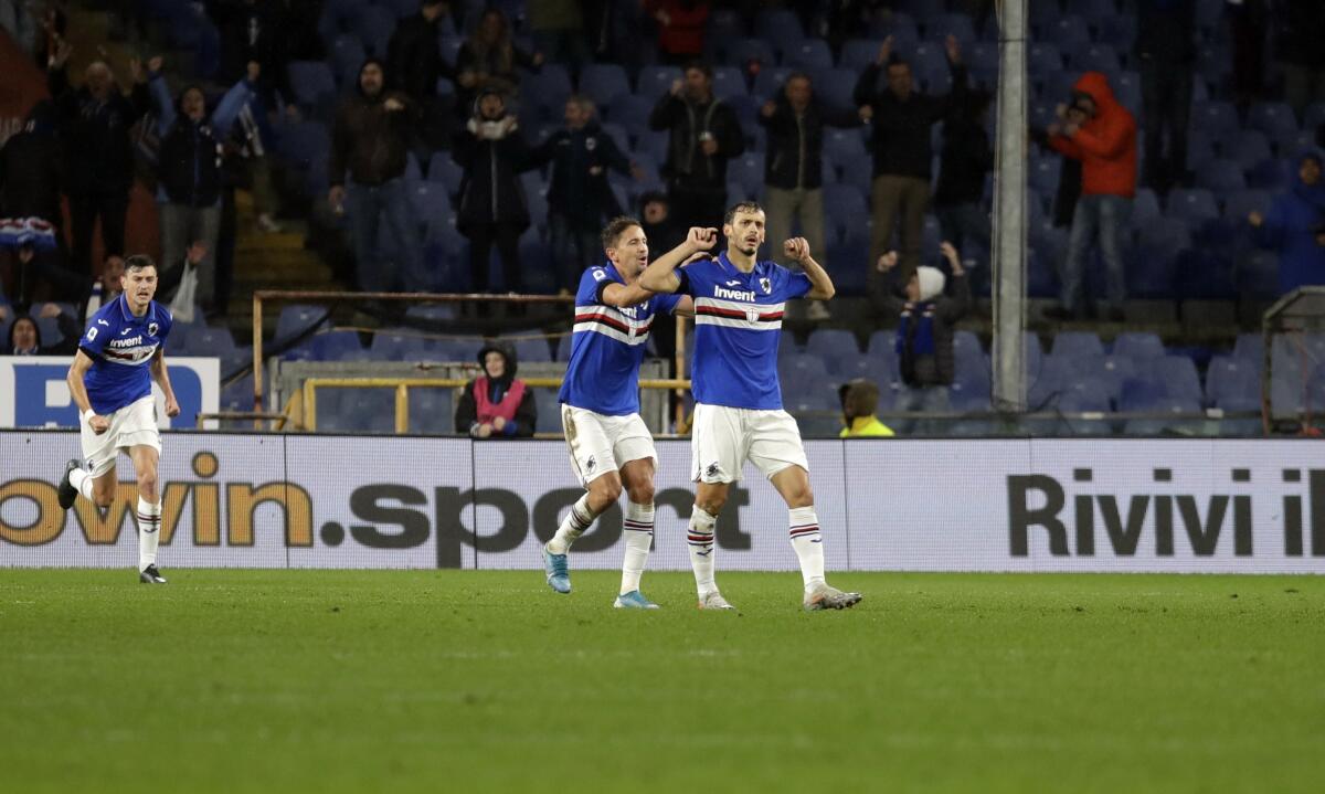 Sampdoria's Manolo Gabbiadini, right, celebrates after scoring his side's opening goal during the Serie A soccer match between Sampdoria and Udinese at the Luigi Ferraris Stadium in Genoa, Italy, Sunday, Nov. 24, 2019. (AP Photo/Luca Bruno)