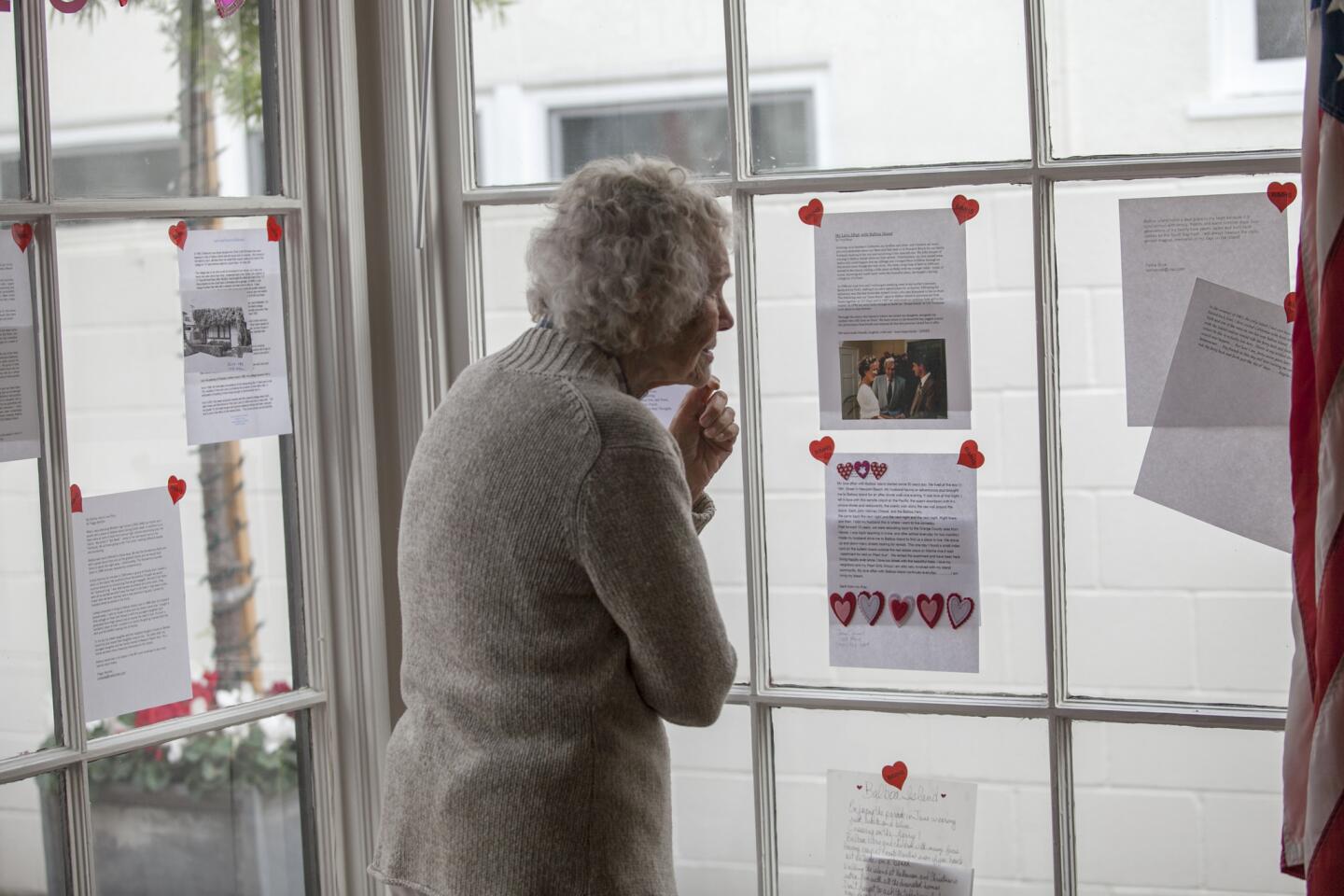 Peggy Marotta looks at love letters about Balboa Island at the Balboa Island Museum & Historical Society on Saturday, February 15. (Scott Smeltzer, Daily Pilot)