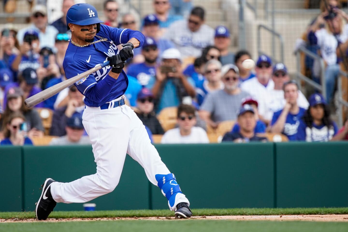 Leadoff hitter Mookie Betts swings at a pitch during his first at bat with the Dodgers during an exhibition game against the Chicago Cubs at Camelback Ranch on Feb. 23.
