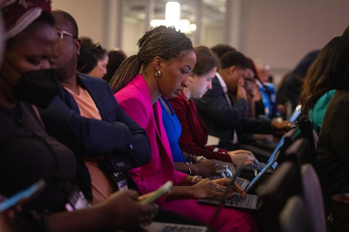 A row of audience members on laptops.