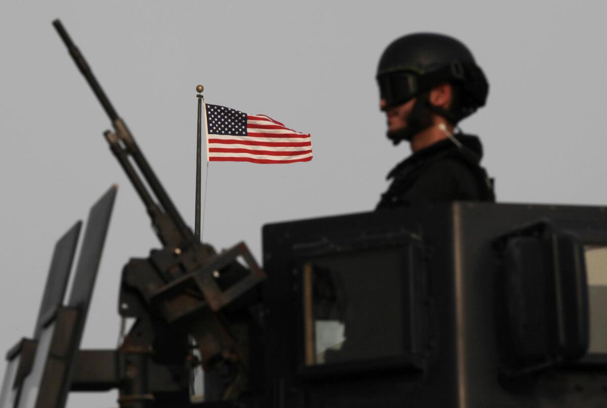 A Bahraini armored personnel vehicle reinforces U.S. Embassy security just outside a gate to the embassy building in Manama, Bahrain, on Sunday.