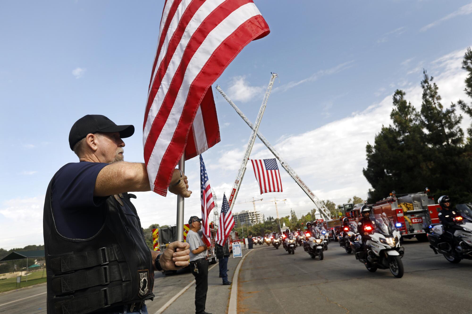 The Patriot Guard Riders stand at attention 