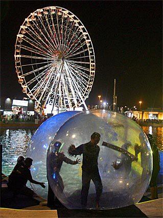 Dancers from a Russian troupe perform inside floating bubbles at a celebration in Dubai for the Feast of Sacrifice.