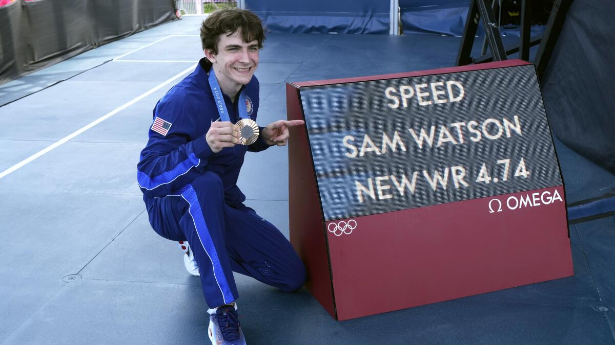 Bronze medalist Sam Watson of the United States celebrates his world record time in Olympic speed climbing.