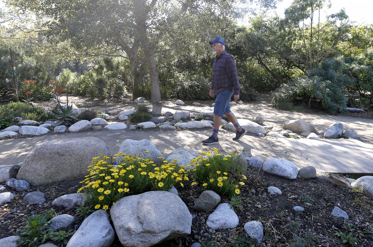 Project Manager Steve Engel walks one of the paths in the Secret Garden in Huntington Central Park.