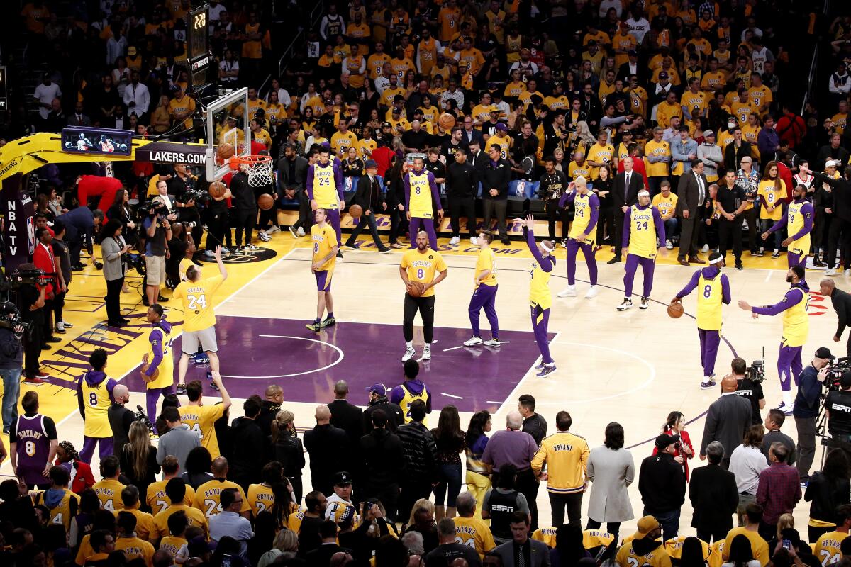 Lakers players warm up before a game against the Portland Trail Blazers at Staples Center.