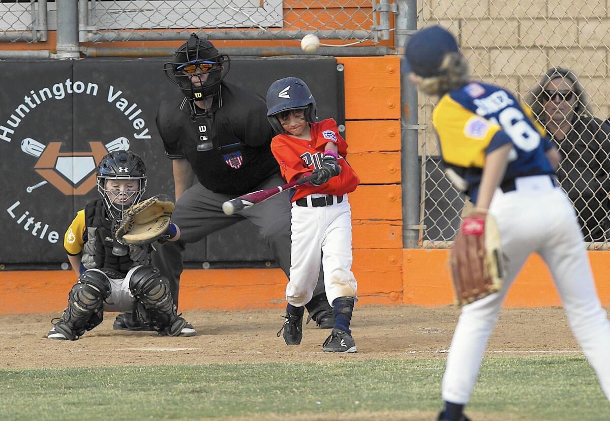 Logan Glabb of the Costa Mesa National Little League Minor B Division Pirates connects in District 62 Tournament of Champions quarterfinal on Tuesday.