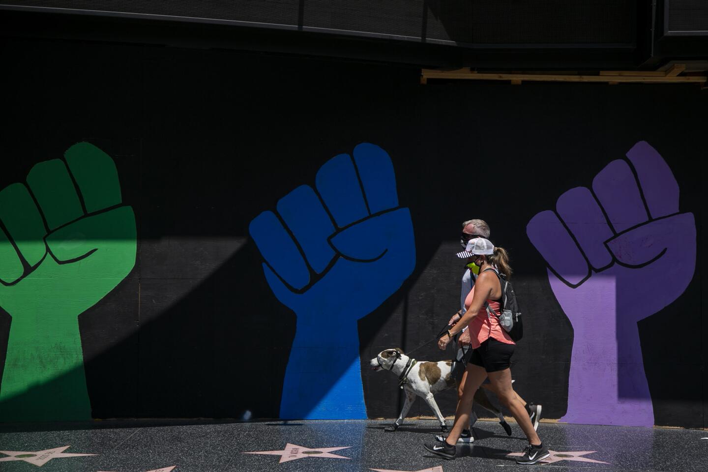 Pedestrians pass a Black Lives Matter mural in Hollywood.
