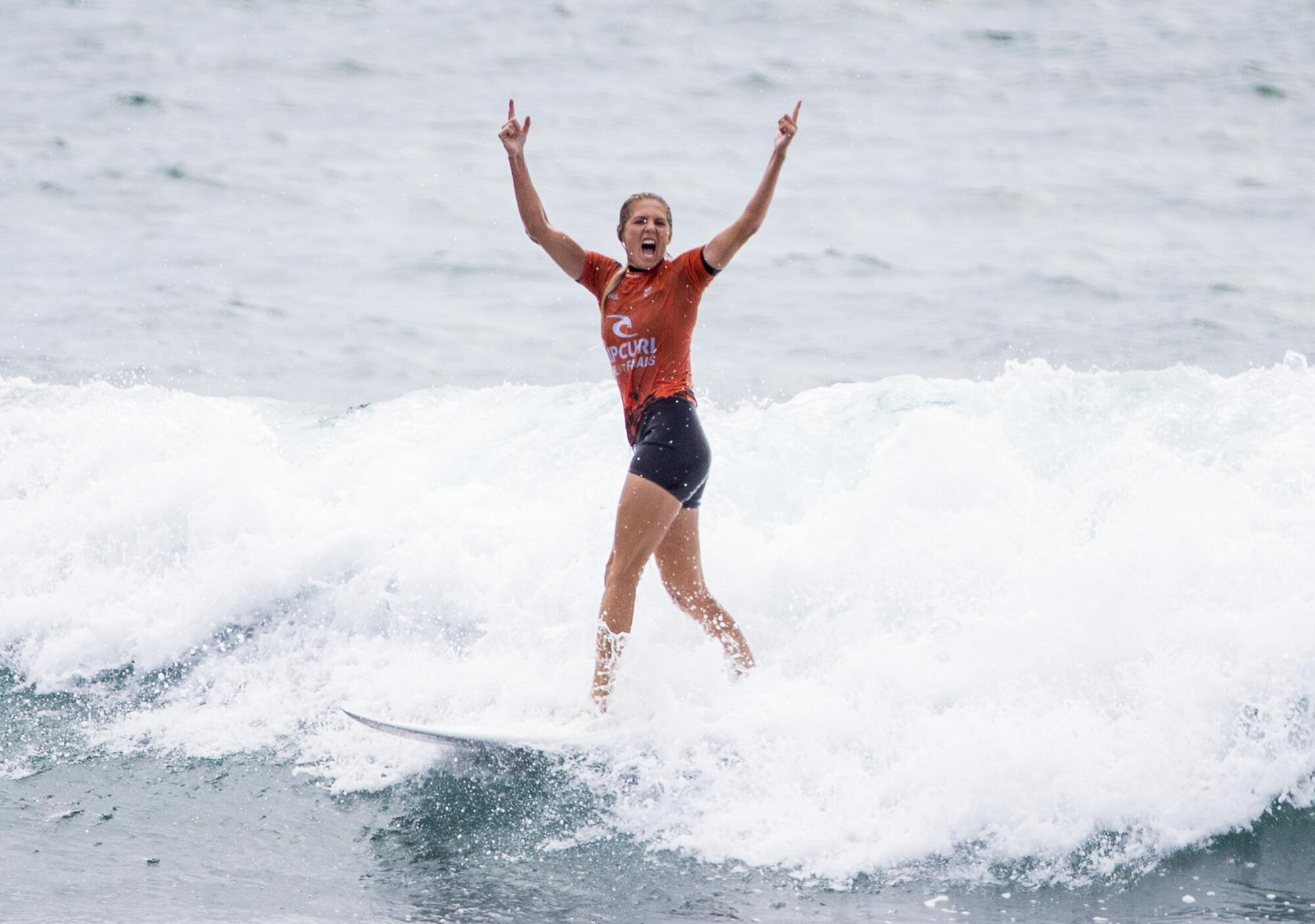 Stephanie Gilmore celebrates after winning the world title.