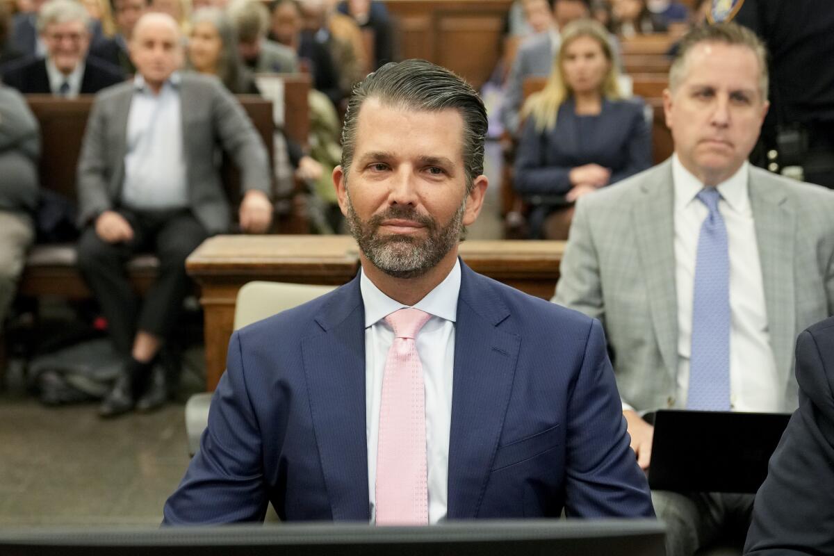 Donald Trump Jr. sitting in front of observers in a courtroom