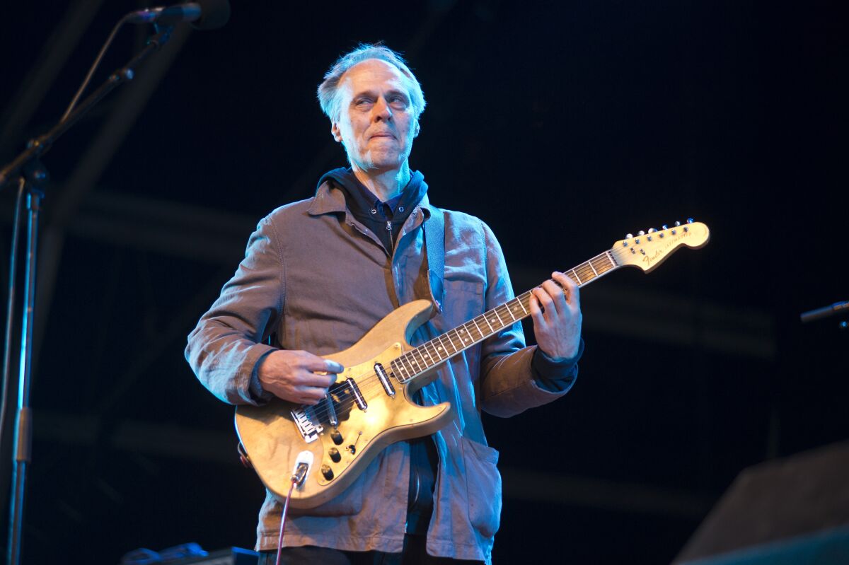 A man playing electric guitar onstage