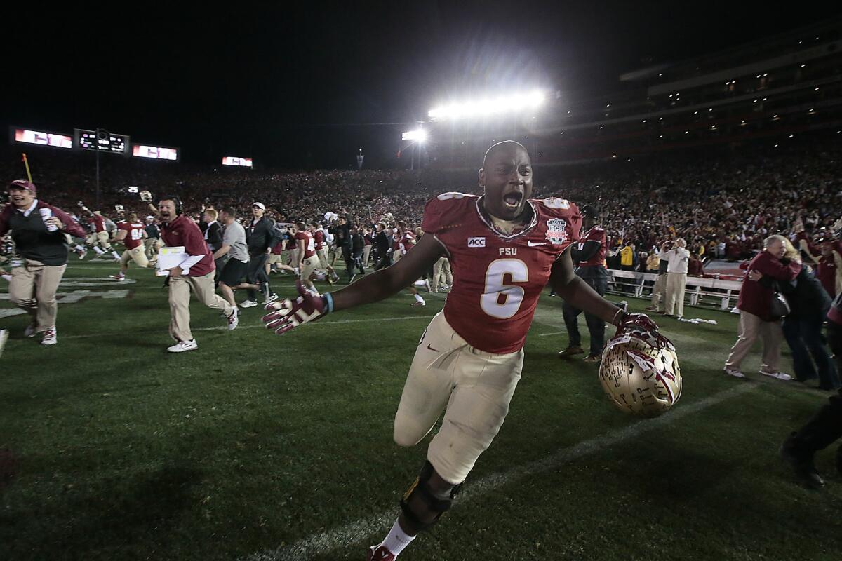 Florida State defensive end Dan Hicks storms the field with the rest of the team after beating Auburn 34-31 in the BCS National Championship at the Rose Bowl.