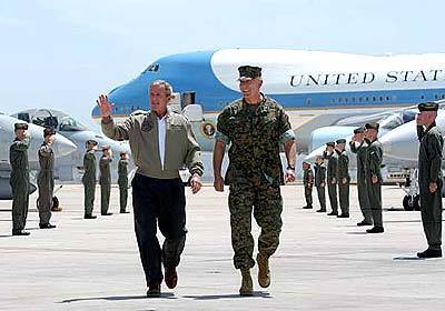 President George W. Bush is escorted along the tarmac by Lt. Gen. James T. Conway of the 1st Marine Expeditionary Force, upon Bush's arrival Thursday at Air Station Miramar in San Diego.