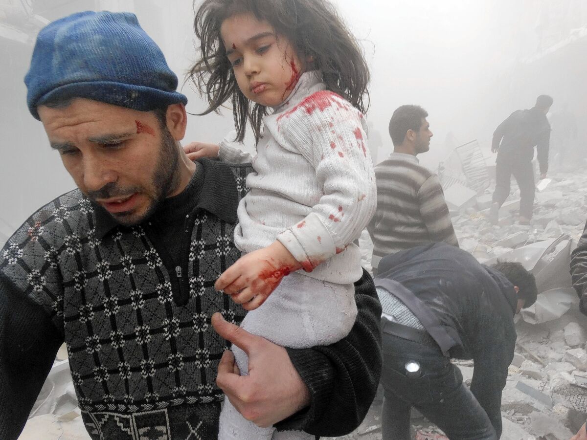 A Syrian man evacuates a child found after government forces dropped a barrel bomb in Aleppo. The Obama administration ordered Syria to close its embassy in Washington “in consideration of the atrocities the Assad regime has committed against the Syrian people.”