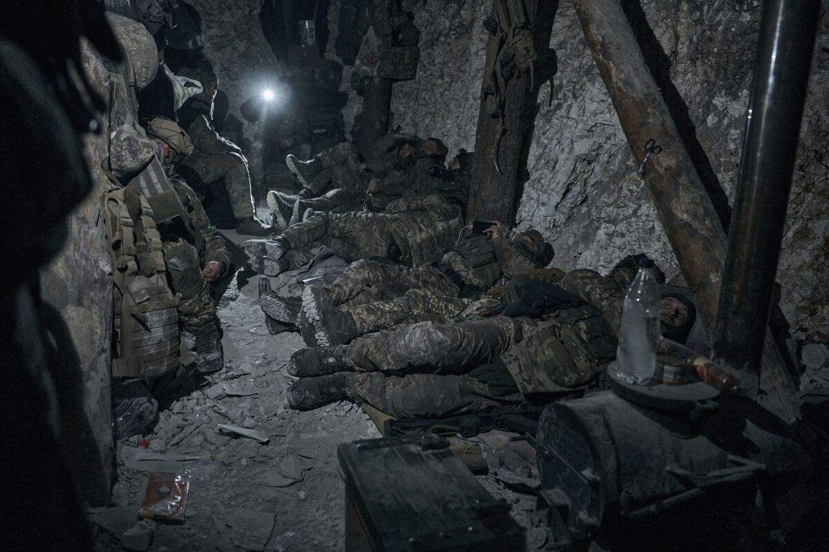 Ukrainian soldiers rest in a blindage after a night fight.