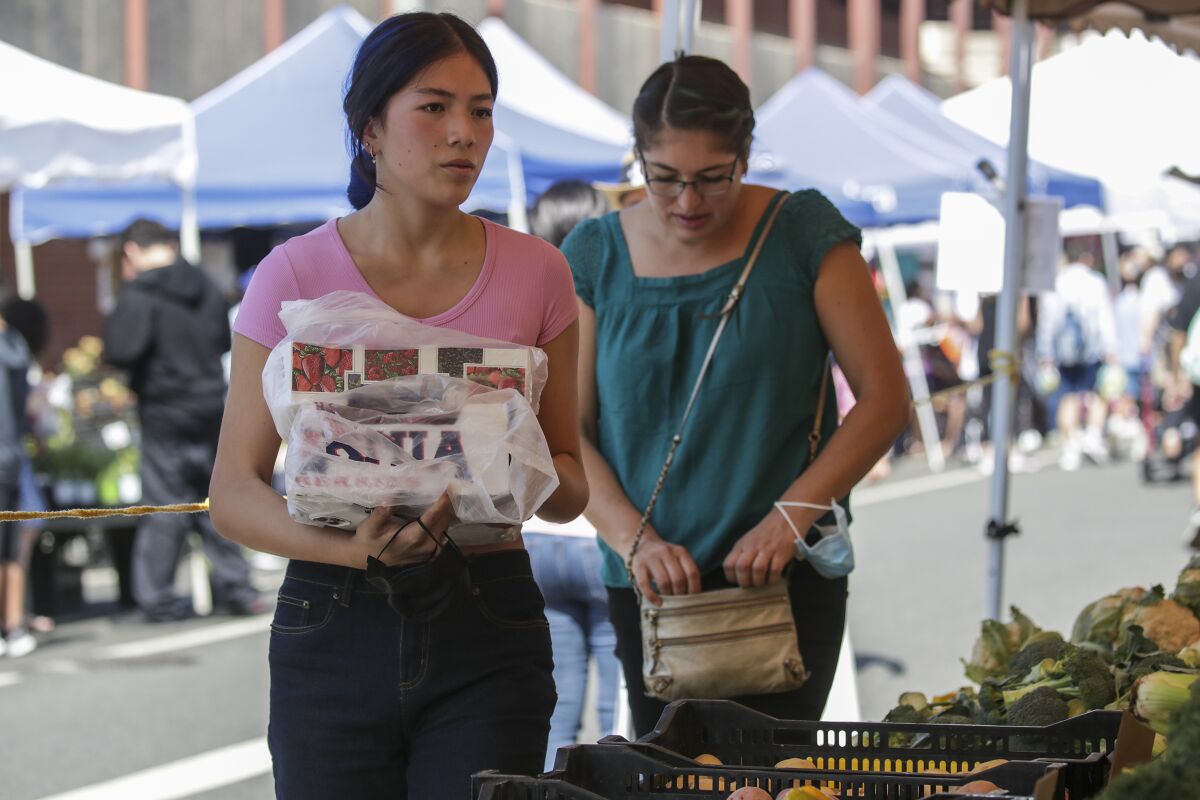 Emily Liu and her mother Beatriz Ortega shop during a Fiesta Alhambra event